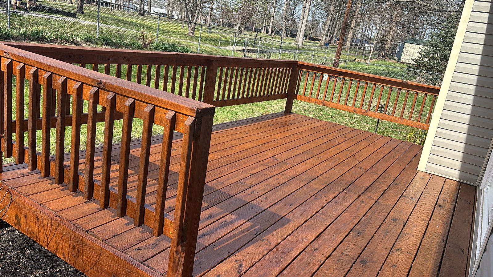 Wood deck freshly stained a rich reddish brown