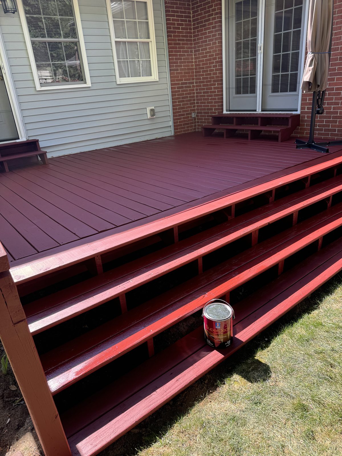 Wood deck and stairs freshly stained a deep red color