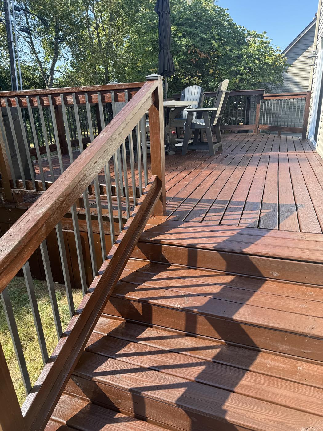 Deck stairs and railing stained a natural cedar tone