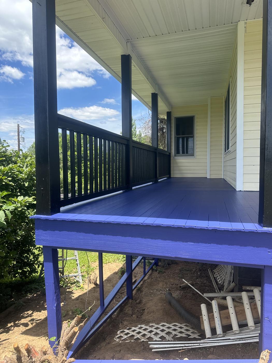 Covered porch and columns painted a bold blue, second angle