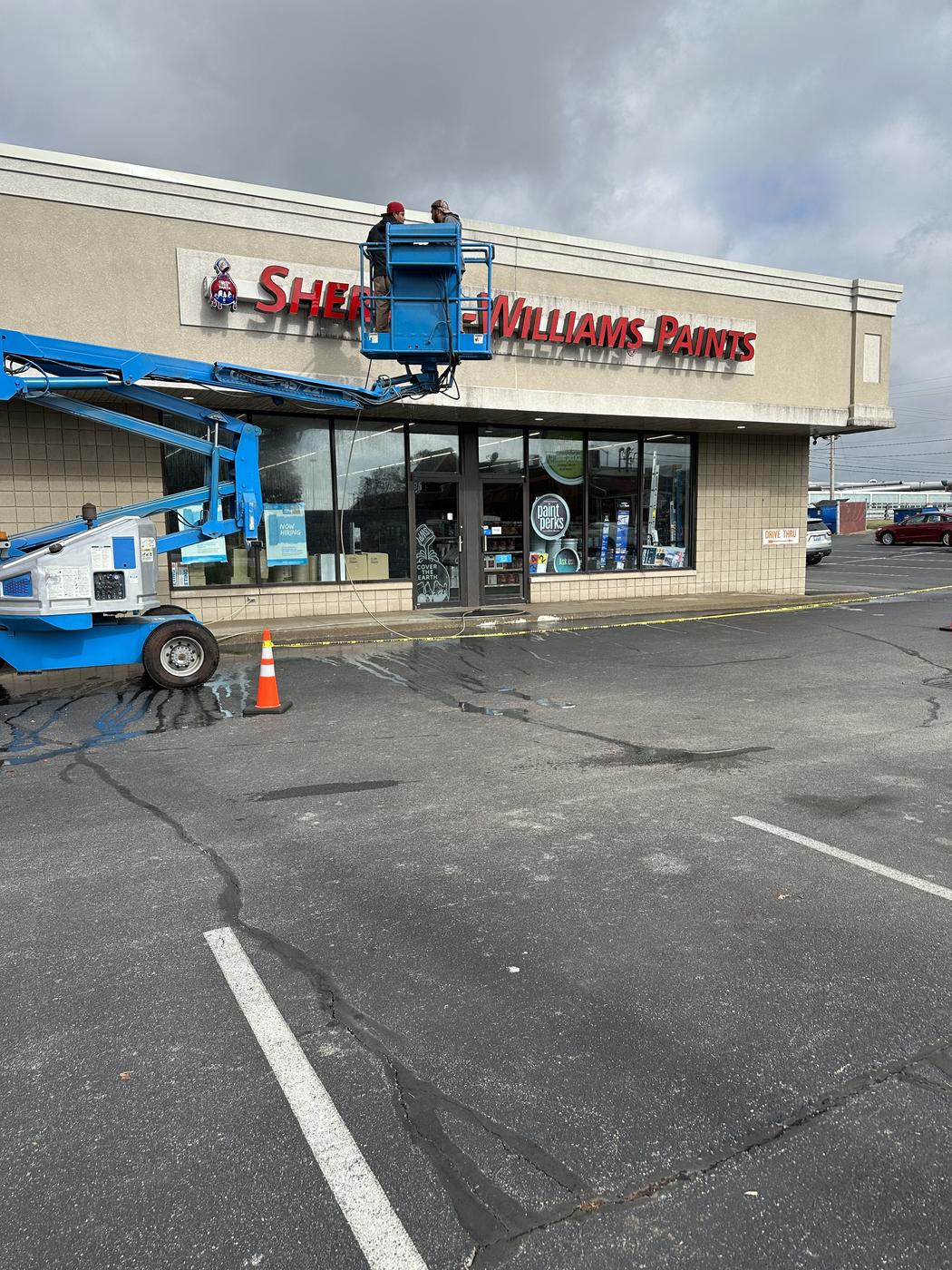 Painting crew working on a commercial storefront exterior