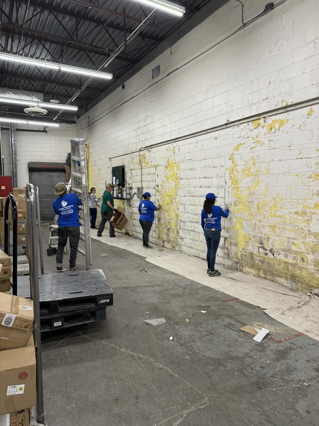 Javier Painting crew painting the interior of a commercial warehouse