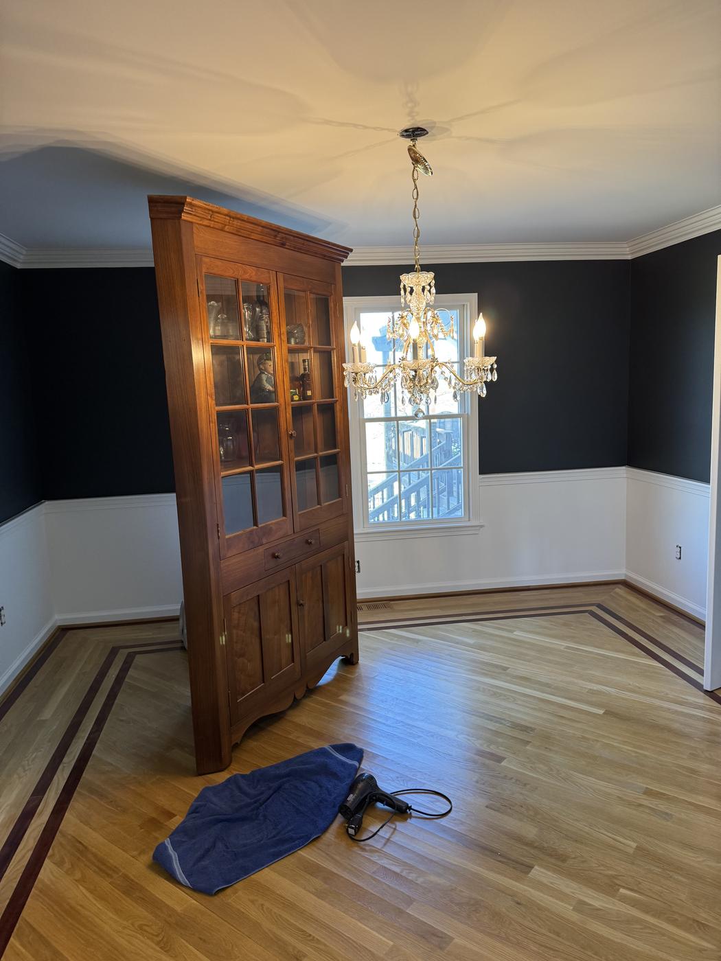 Dining room with a dark navy accent wall and crisp white trim