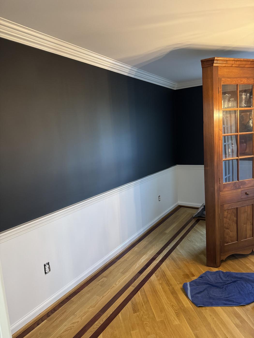 Freshly painted crown molding and two-tone accent wall