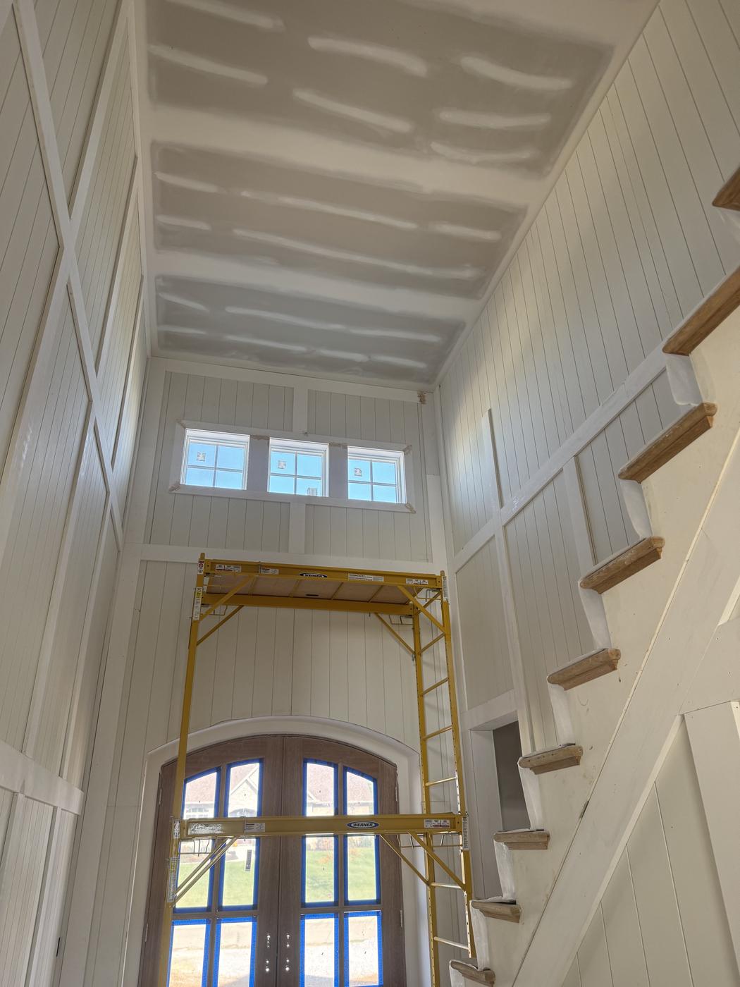 Vaulted ceiling with board and batten trim, freshly painted white