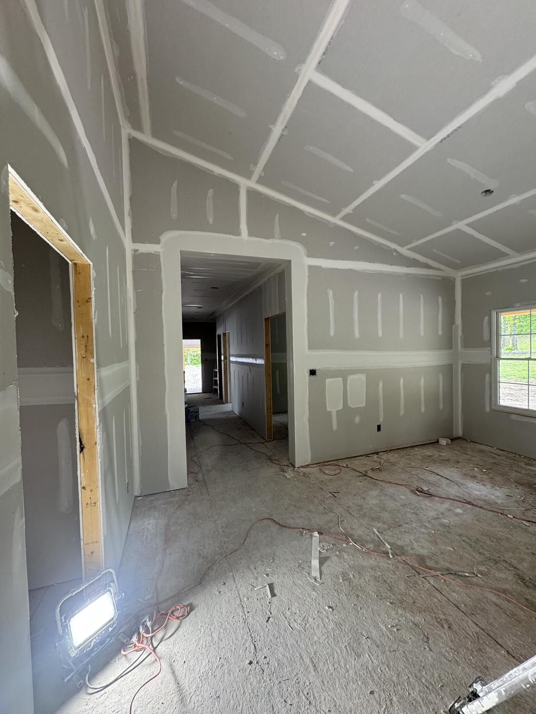 New construction room with drywall taped and mudded, ready for paint