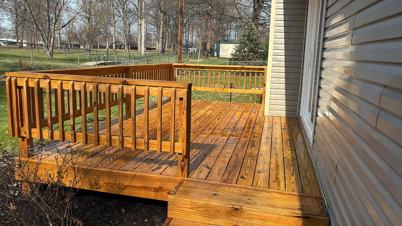 Wood deck and railing freshly stained a warm honey tone