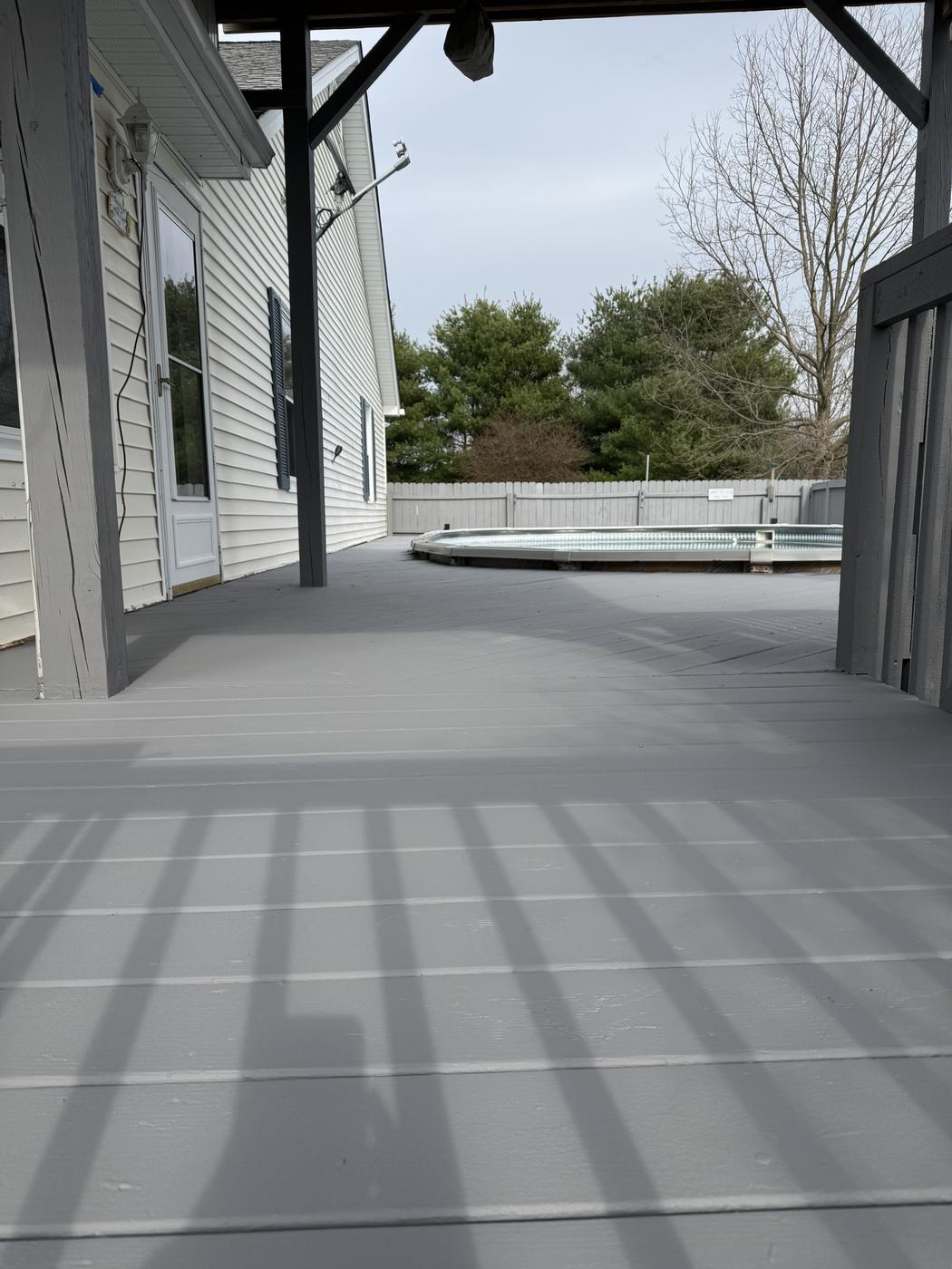 Covered patio with freshly painted gray floor