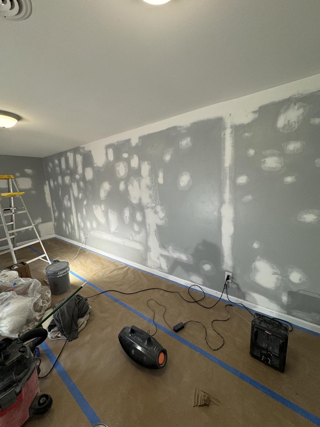Room mid drywall repair with fans and floor protection set up