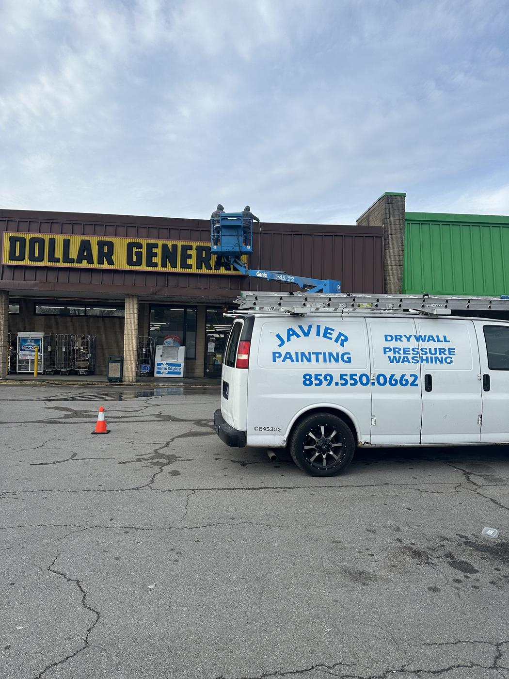 Javier Painting van parked at a retail storefront job site