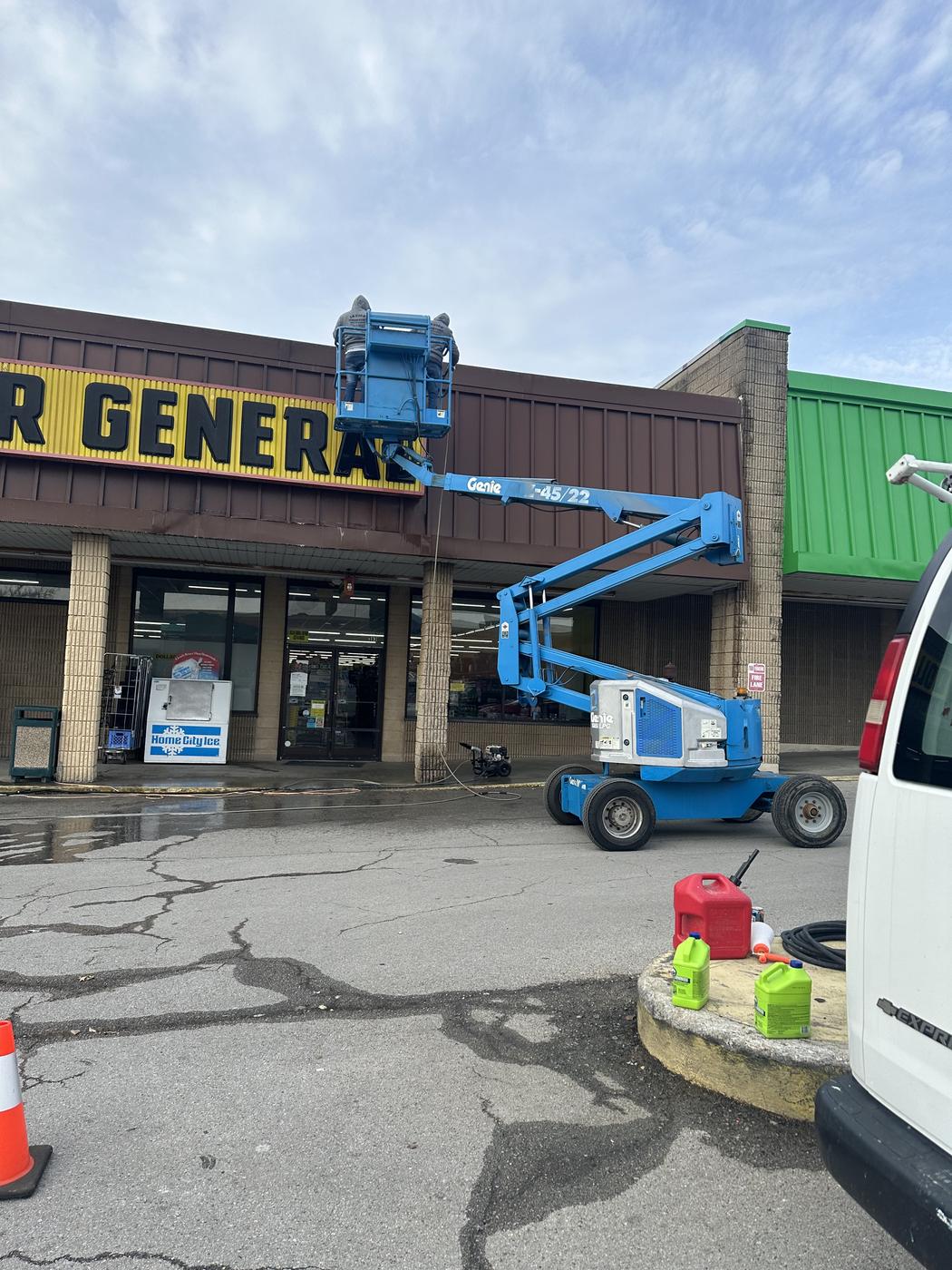 Lift equipment and van set up at a retail storefront