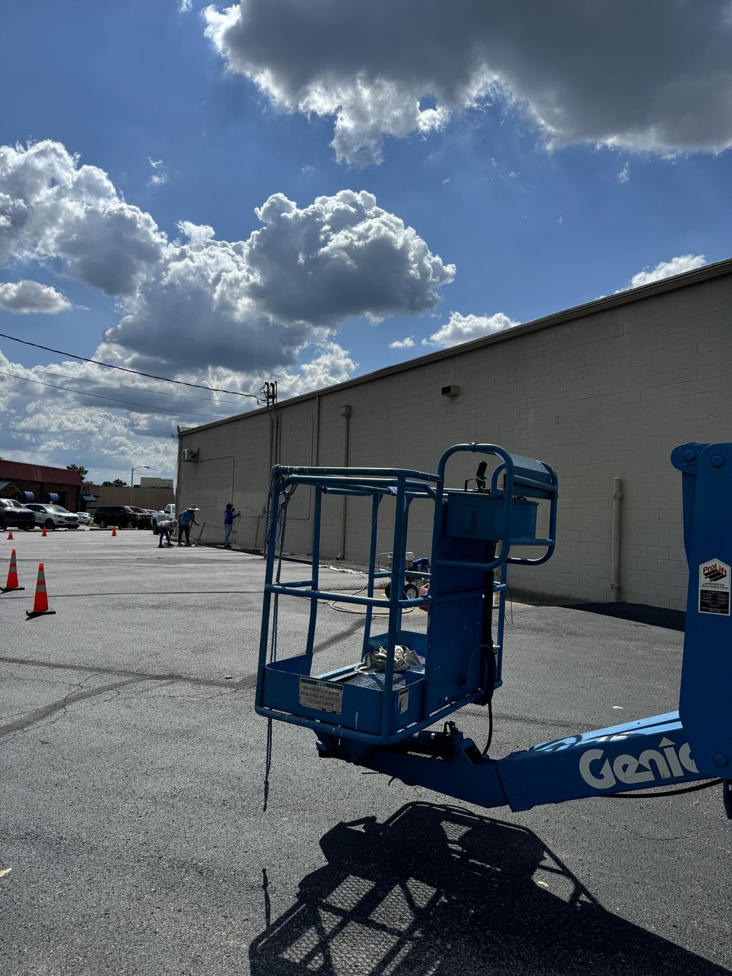 Lift equipment staged in a commercial parking lot