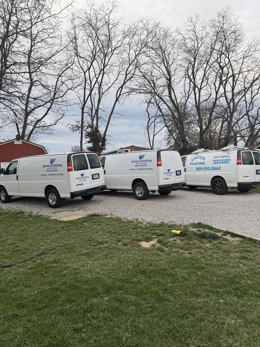 A row of Javier Painting vans parked together, ready for work