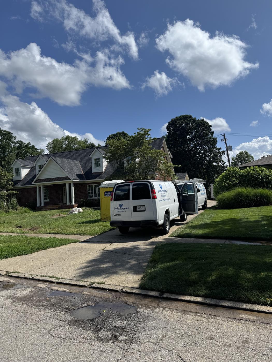 Javier Painting van parked in a residential neighborhood